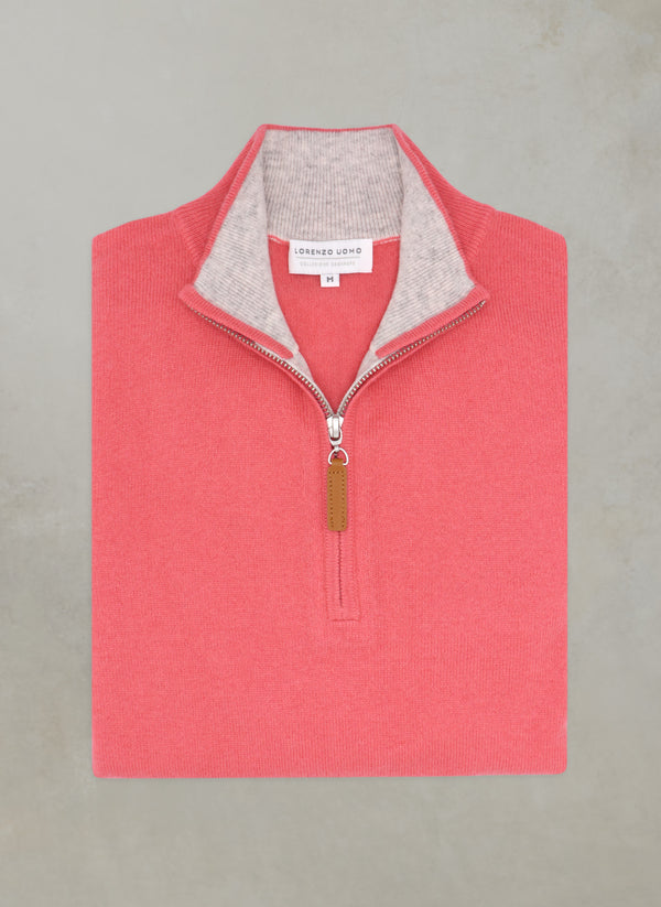 flat lay image of a solid quarter zip cashmere sweater in coral with light grey contrasting inside of collar