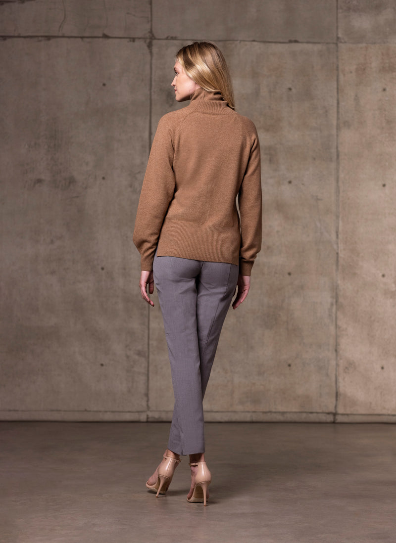 back image of Women's Cinzia Turtle Neck Cashmere Sweater in Camel with light grey pants and neutral heels
