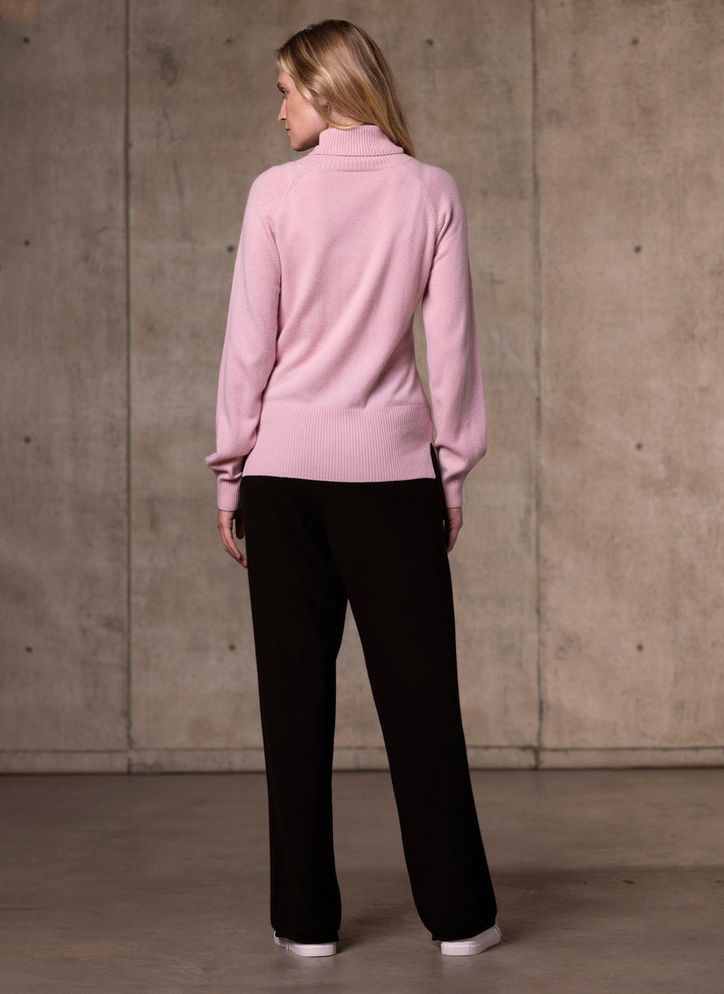 back image of Women's Cinzia Turtle Neck Cashmere Sweater in Light Pink featuring our luxurious cashmere wide leg pants in black 