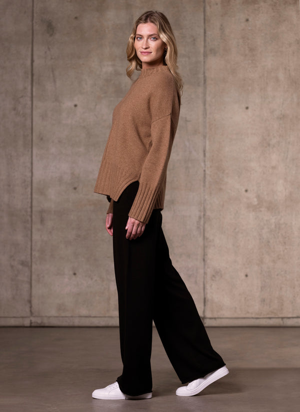 Side image of Women's Alessandra Mock Neck Knitted Cashmere Sweater in Camel  featuring our luxurious cashmere wide leg pant