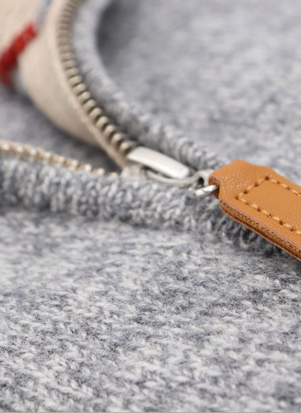 close up image of our 100% merino wool sweater in light grey showing the ykk zipper detail