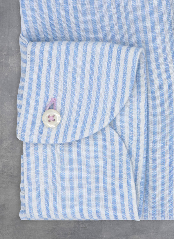 light blue and white stripped linen cuff with white buttons and purple button hole and thread
