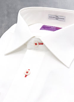 white formal shirt with red button holes and button thread
