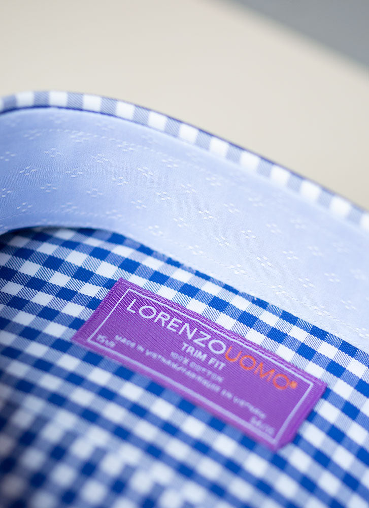 inside collar detail of blue check shirt with dash fabric inside the collar 