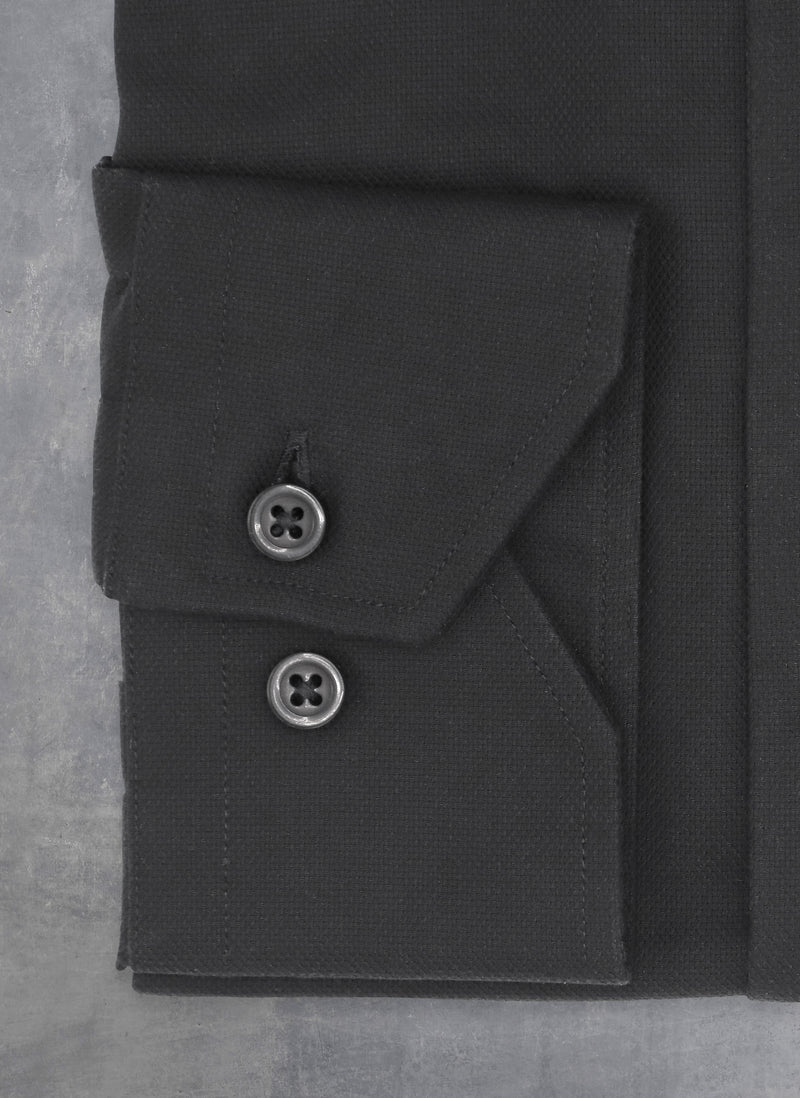 cuff detail with black buttons and thread 