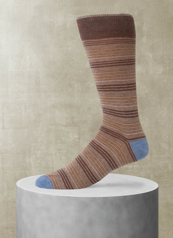Striped sock with brown and blue pattern on a beige background