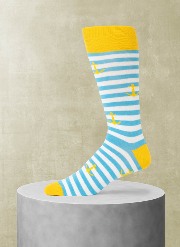 Striped sock with yellow accents and anchor pattern on a beige background