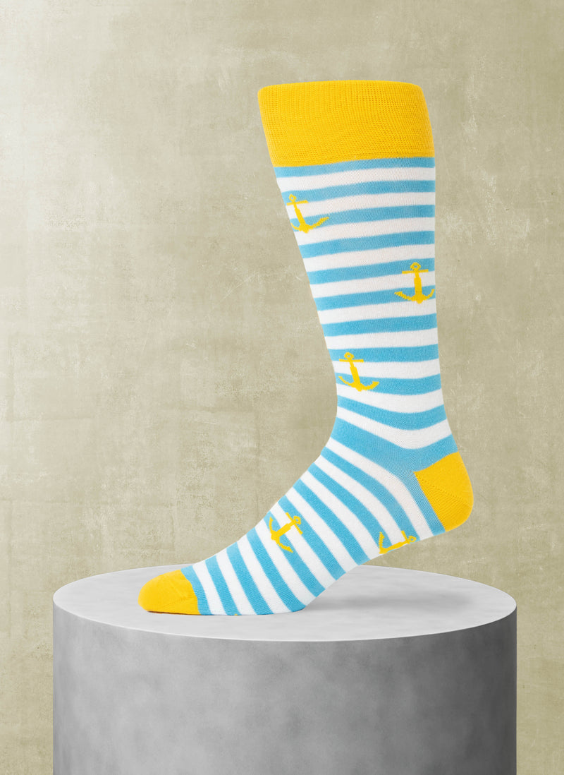Striped sock with yellow accents and anchor pattern on a beige background