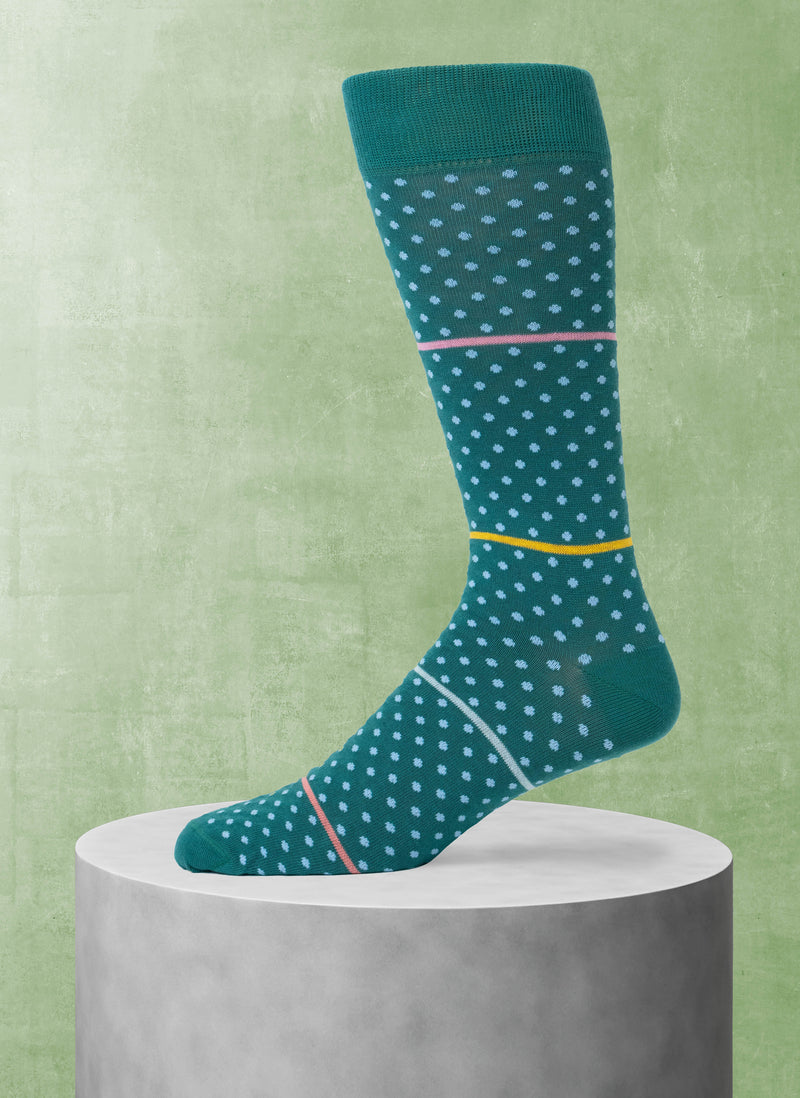 Green sock with light green polka dots on a green background
