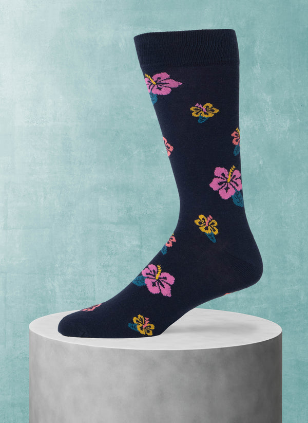 Navy sock with colorful floral patterns on a light blue background