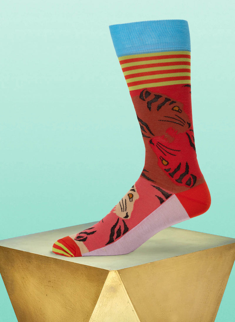 Colorful sock with tiger design on a light blue background