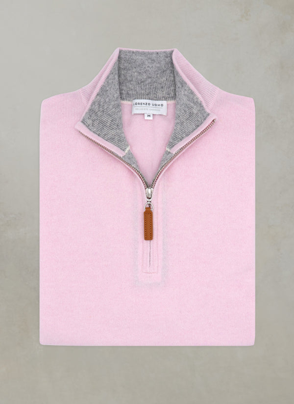 flat lay image of a solid quarter zip cashmere sweater in light pink with light grey contrasting inside of collar