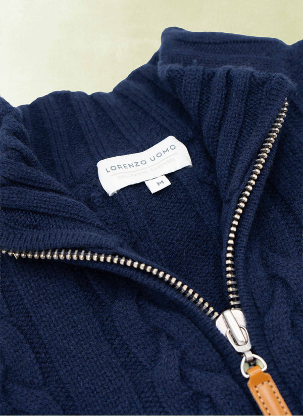 Navy blue fleece jacket with a brand label on a light background