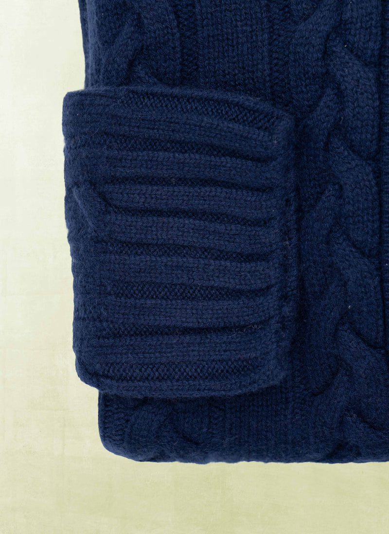 Close-up of a navy blue knitted fabric on a light background