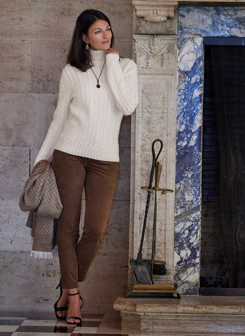 Women's Giulia Turtle Neck Cable Cashmere Sweater in Ivory Holding 100% Cashmere blanket 