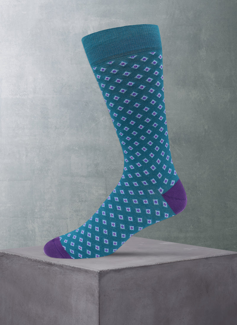 Blue and purple patterned sock on a gray surface