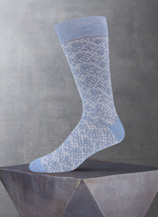 Blue patterned sock on a gray surface