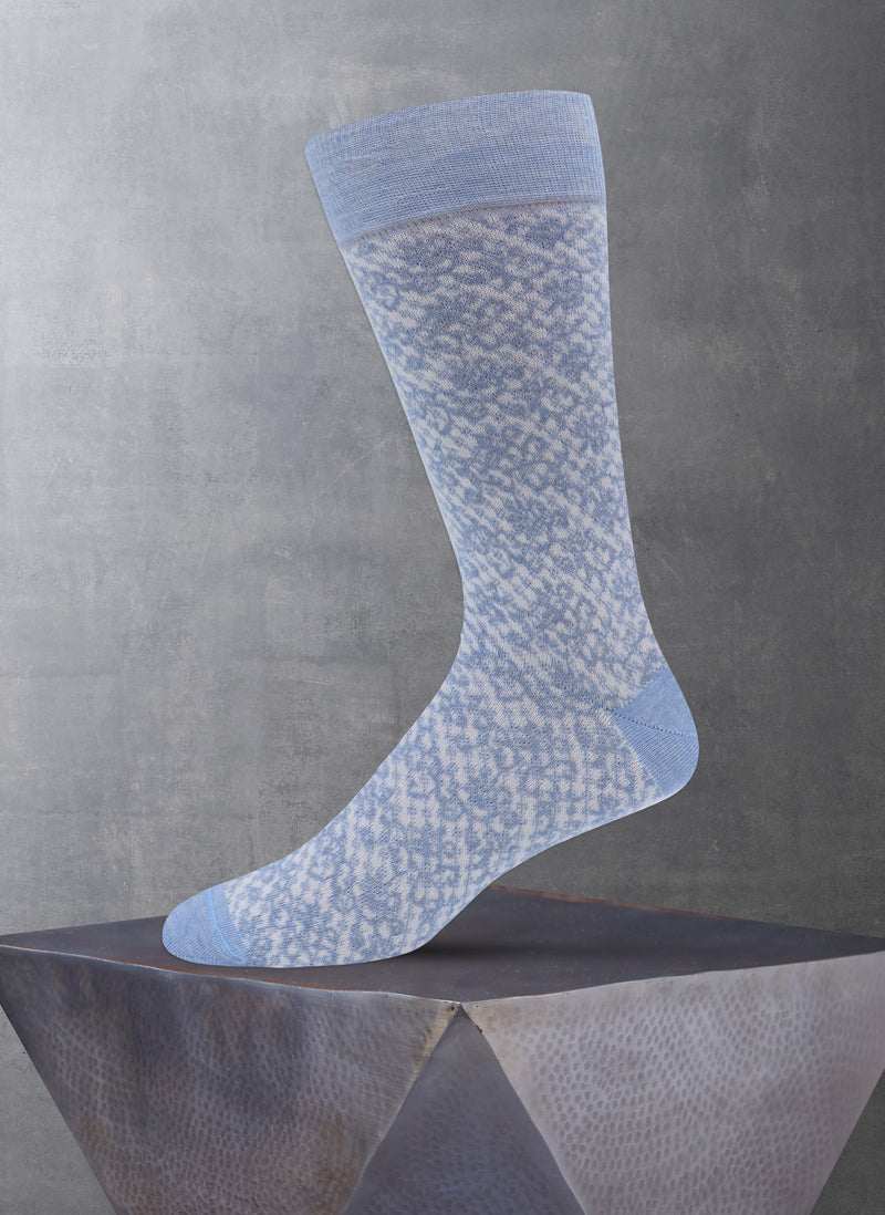 Blue patterned sock on a gray surface