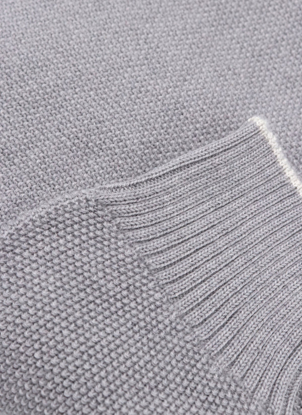 close up of ribbed cuff on a merino wool crew neck sweater in light grey