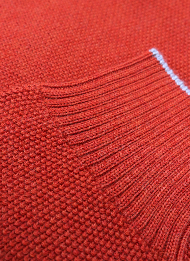 close up of ribbed cuff on a merino wool crew neck sweater in rust mélange 