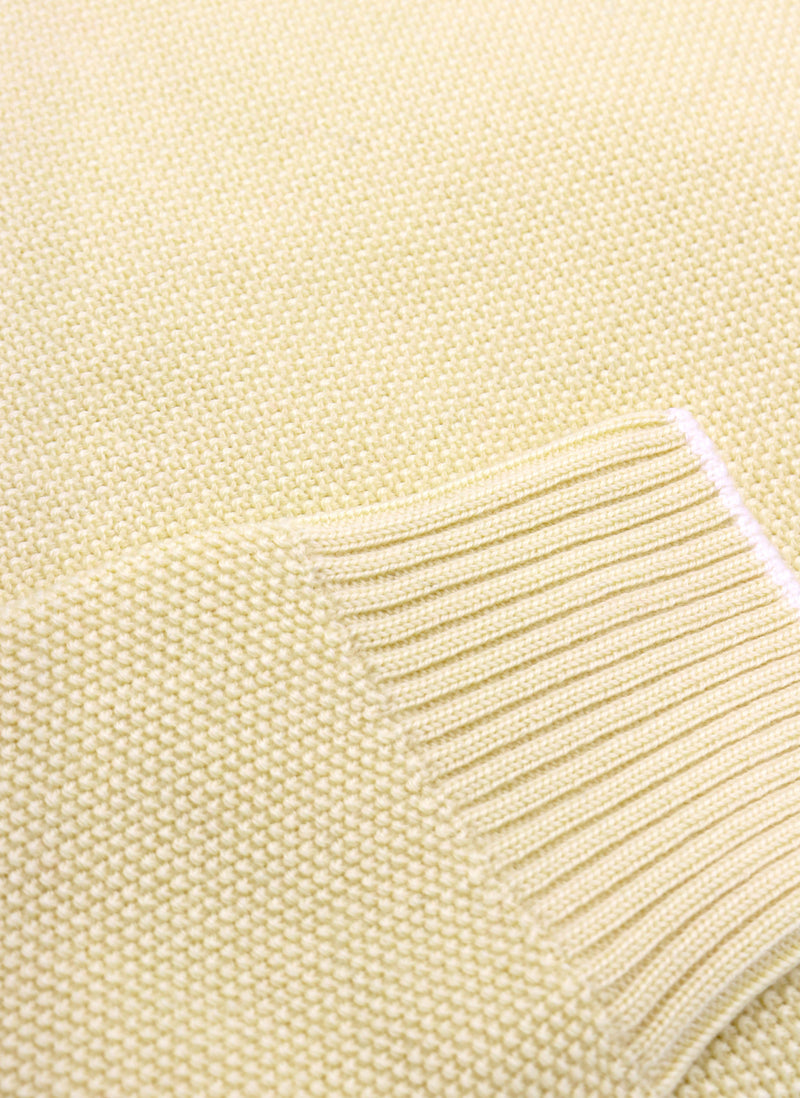 close up of ribbed cuff on a merino wool crew neck sweater  in yellow