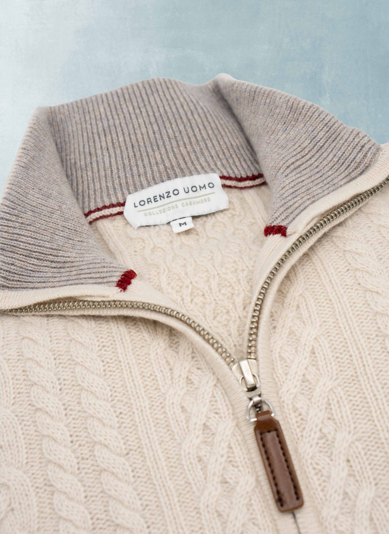 Close-up of a cable knit sweater with a zipper, featuring the Lorenzo Vado brand label.
