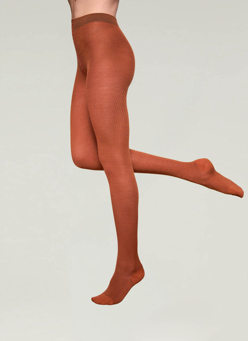 Brown tights worn by a person on a light gray background