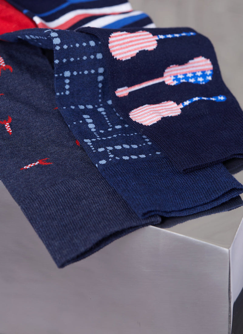 Group image of a rocket sock in navy, dot sock in navy and American flag guitar sock in navy