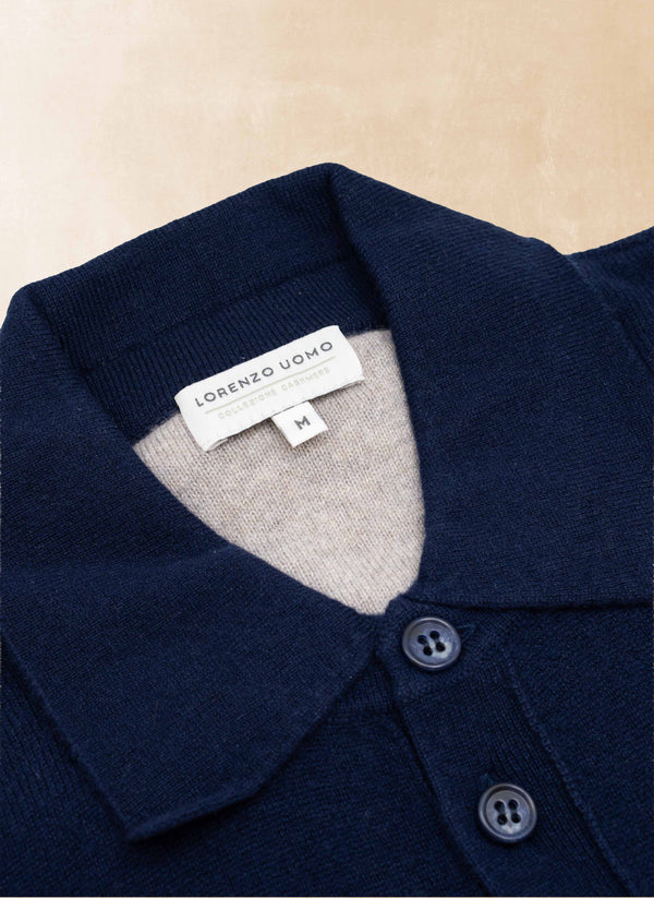 Navy blue garment with a gray collar and 'Lorenzo Uomo' label on a beige background