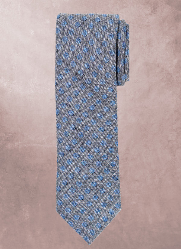 Gray tie with blue pattern on a beige background