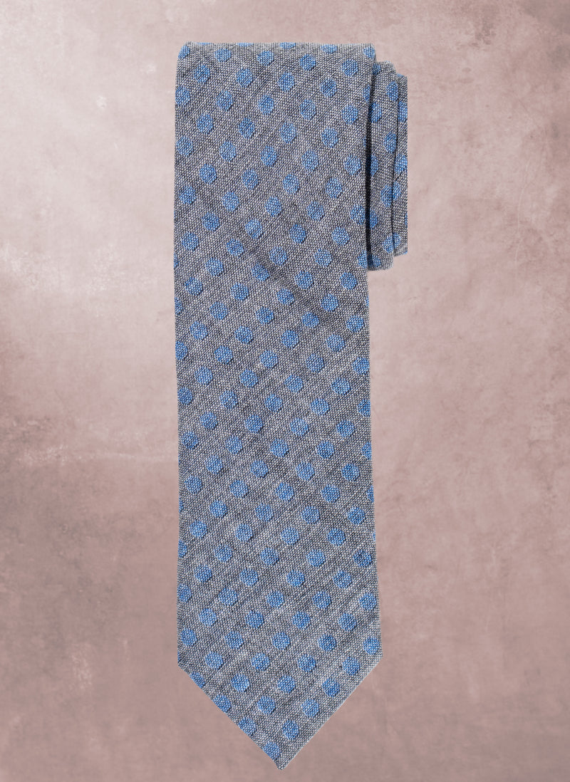 Gray tie with blue pattern on a beige background