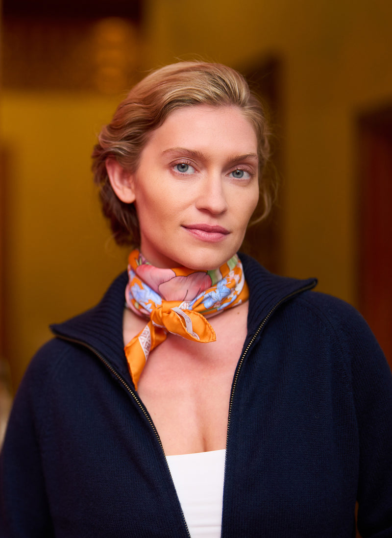 Woman wearing a colorful scarf with a blurred background