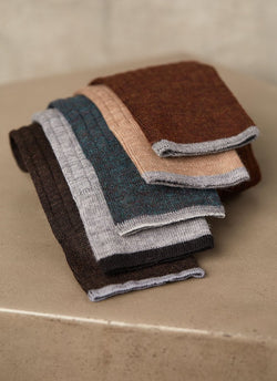 rolled up big and tall merino wool socks in argento, brown, taupe, light grey and brown