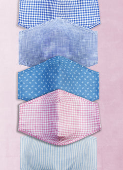 Hamptons Pastel Linen Non-Medical Masks (Assorted Pack of 5) Contains one mask with Gingham pattern in Blue and White, also contains one mask with houndstooth pattern in Dark Blue and White, also contains one mask with allover floral in Blue, also contains one mask with Gingham pattern in Pink and White, also contains one mask with Stripe pattern in Blue and White.