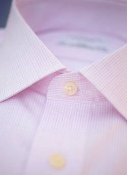 collar of pink check shirt with white buttons