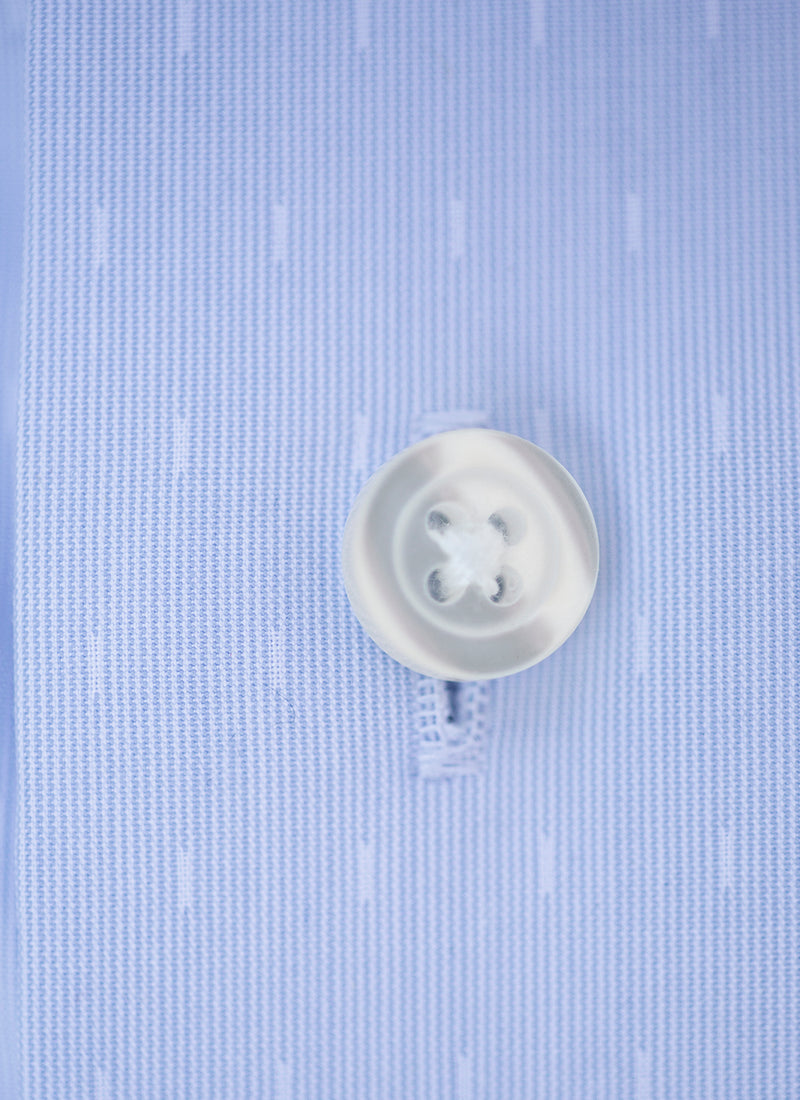 blue dash fabric with a white button and button thread