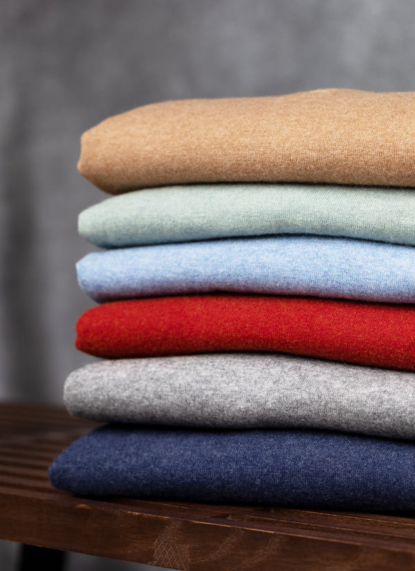 stacked quarter zip cashmere sweaters in tawny, sea form, sky blue, cinna, light grey and navy