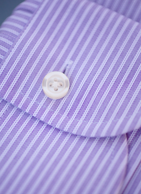 cuff detail of purple stripe shirt with white button and stuff