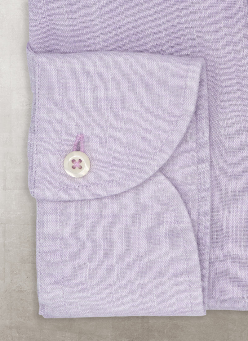 solid linen cuff in purple with white button and a purple button hole and thread