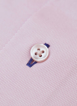 light pink button with navy blue button hole