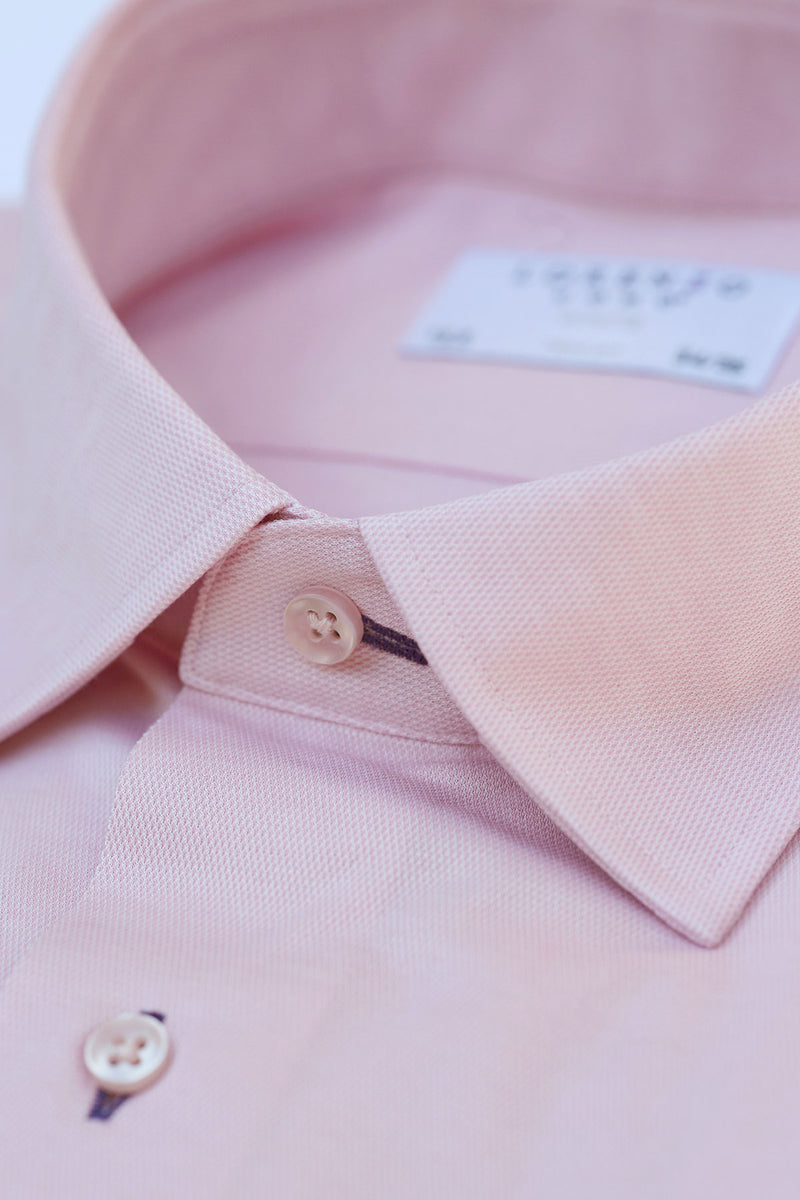 collar detail of pink knit shirt