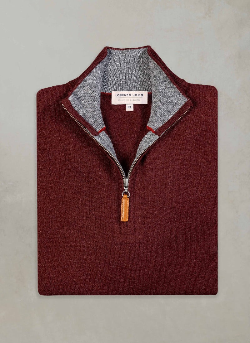 flat lay image of a solid quarter zip cashmere sweater in burgundy with light grey contrasting inside of collar