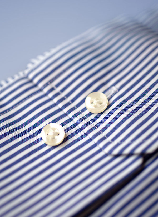 dark blue stripe cuff detail with white buttons