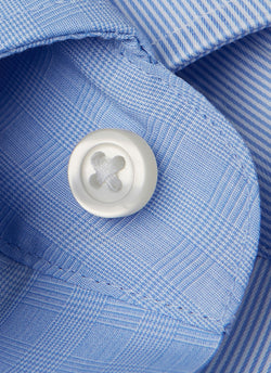 white button and button thread detail on blue glen plaid shirt