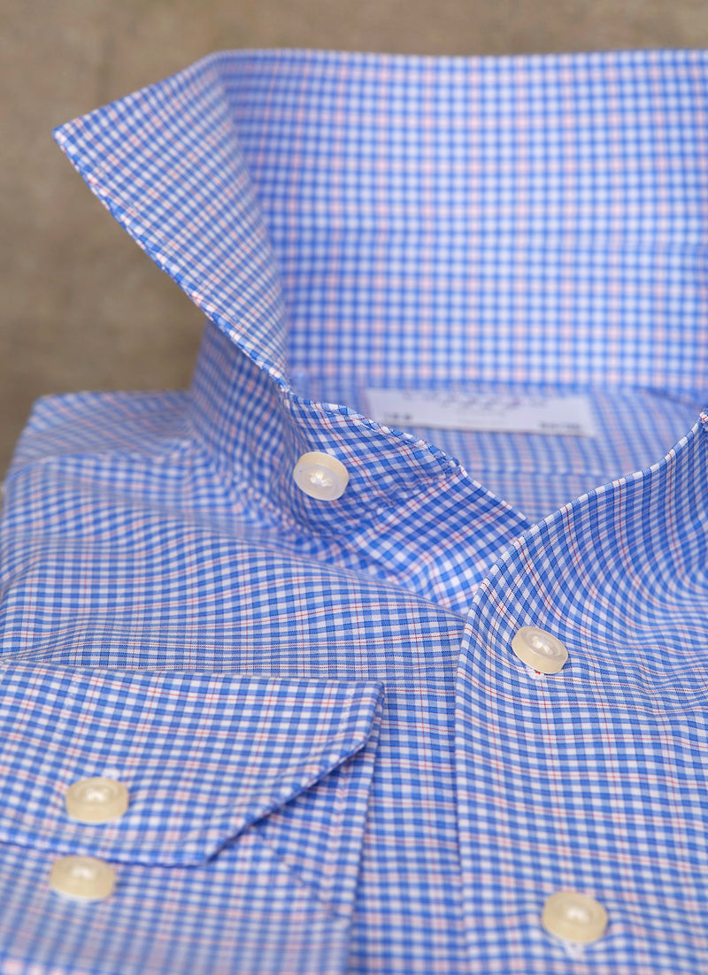 popped collar of blue and red multicheck shirt with white buttons, button holes and button threads