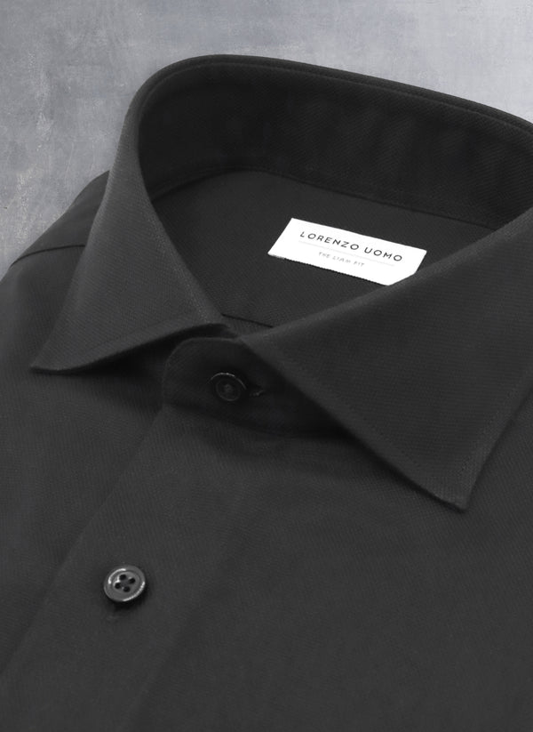 collar detail of solid black oxford shirt with black buttons and button threads